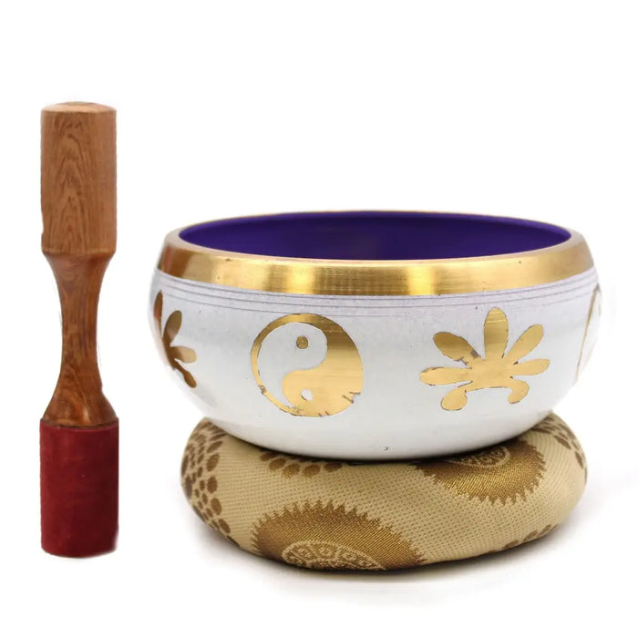 Large white tibetan singing bowl set with gold accents featuring yin yang symbol and floral designs on a golden cushion