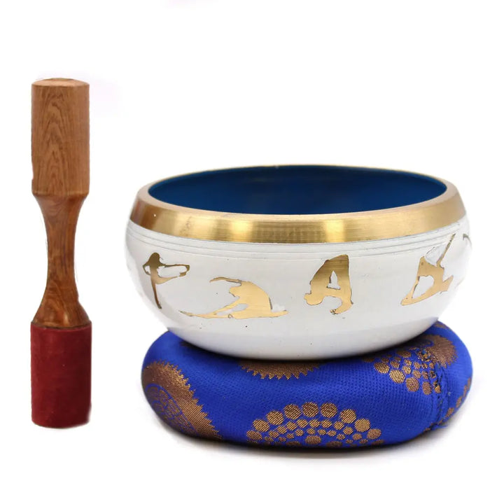 White and blue large singing bowl set with gold trim and golden yoga moves designs inside the bowl