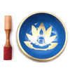 Blue singing bowl set with gold lotus and buddha design and wooden mallet for yoga moves and meditation use