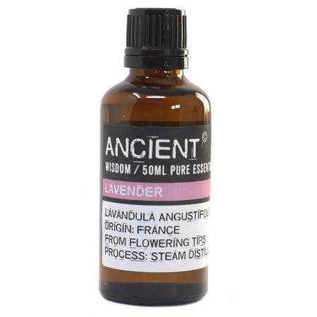 A 50ml amber glass bottle of ancient wisdom lavender essential oil with black ribbed cap and allergen declarations for skin sensitivity