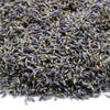 A pile of dried lavender flowers with soft purple and muted green hues showing slender elongated buds
