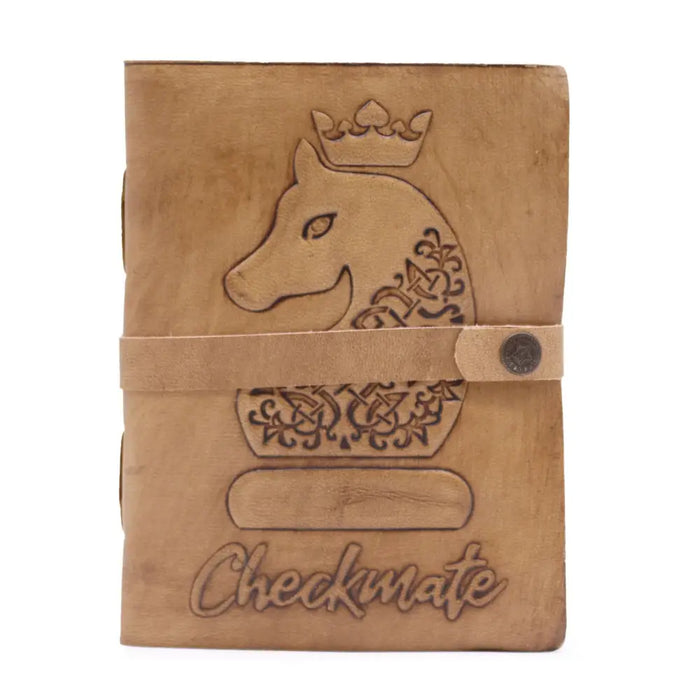 Tan leather notebook with an engraved crowned horse head ornate patterns and check mate embossed at the bottom