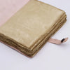 A light tan leather notebook with aged parchment pages and a soft pink binding strap check mate style