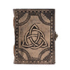 A vintage leather notebook in antique grey with a circle triquetra and black embossed patterns on the cover