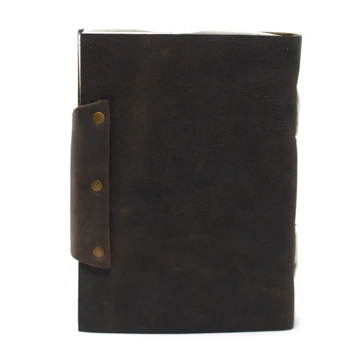 Dark brown leather notebook with matching strap fastened by three brass rivets sized 7 by 5 inches