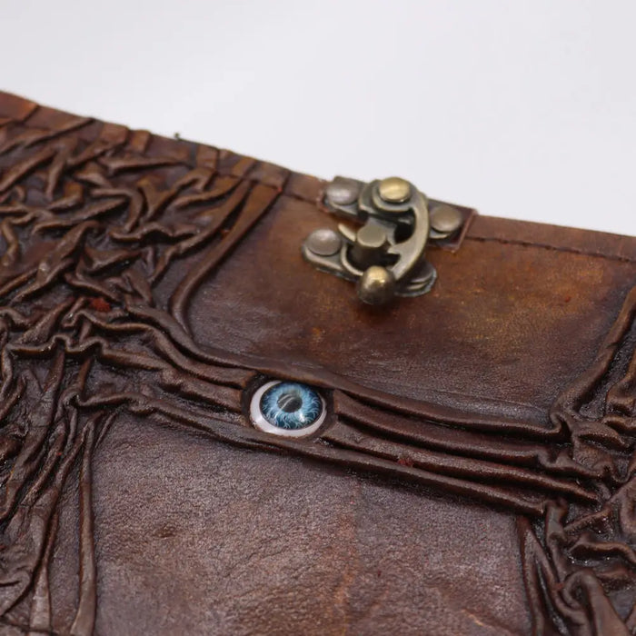 Brown leather notebook with embossed tree design black tan color metallic clasp and evil eye detail