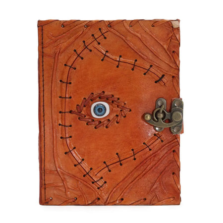 Tan leather notebook with stitched evil eye design and metal clasp in an 8 by 6 inch leather notebook