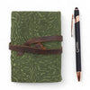 Olive green leather notebook with embossed green maze pattern and brown strap featuring deckled edges 5 by 3 and a half inches