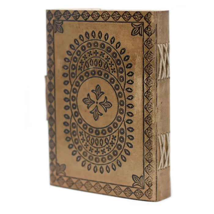A tan leather notebook with black embossed mandala patterns and decorative stitched binding measuring 7 by 5 inches