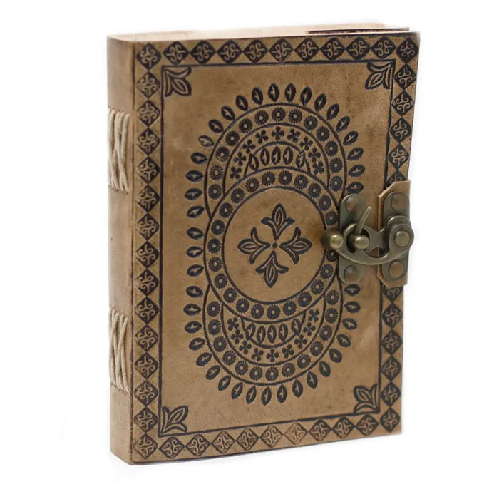 A vintage-style leather notebook with black embossed mandala patterns and a brass clasp measuring 7 by 5 inches
