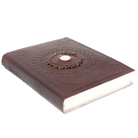 Brown leather notebook with embossed patterns and a circular metal accent sized 7 by 5 inches