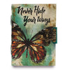 A leather notebook with a teal and beige distressed cover featuring a monarch butterfly and antique brass clasp