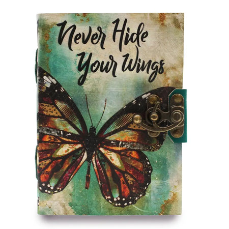 A leather notebook with a teal and beige distressed cover featuring a monarch butterfly and antique brass clasp