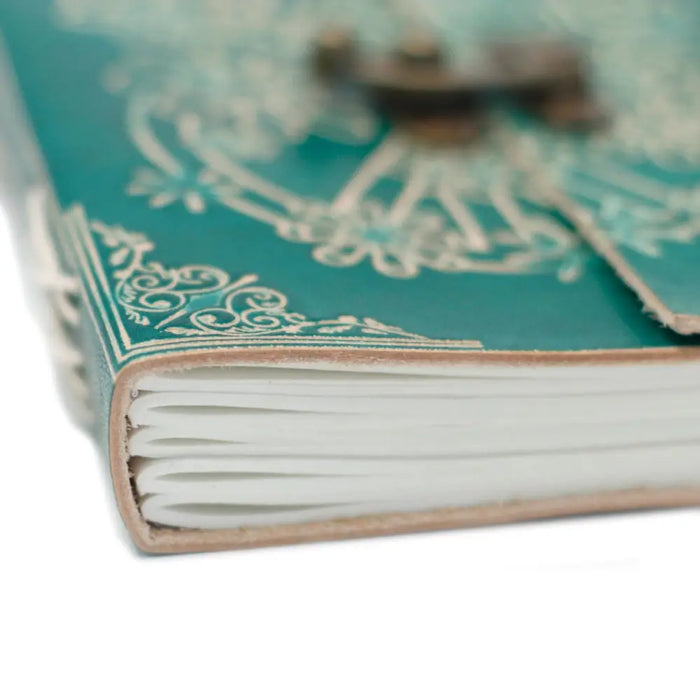 Teal leather notebook with white floral embossing and brass clasp in a 7x5 inch leather notebook peace design