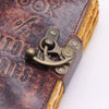 Brown leather notebook with embossed title the book of untold stories and brass anchor clasp on leather cover