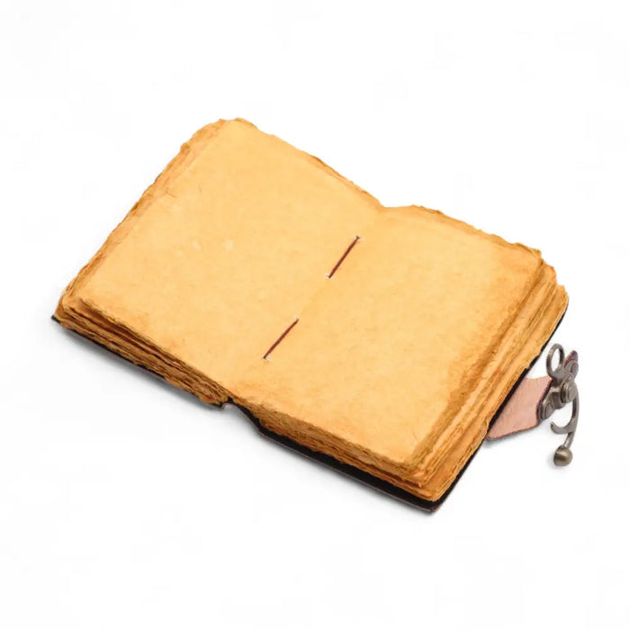 A leather notebook with a leather cover, aged yellow pages, decorative clasp, and deckled edges for untold stories