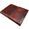 Brown leather notebook with tree of life design and green gemstone clasp on a leather cover measuring 8 by 6 inches
