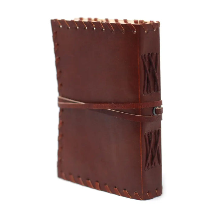 Brown leather notebook with stitched edges and wrap strap closure sized 6 by 4 inches for jotting thoughts