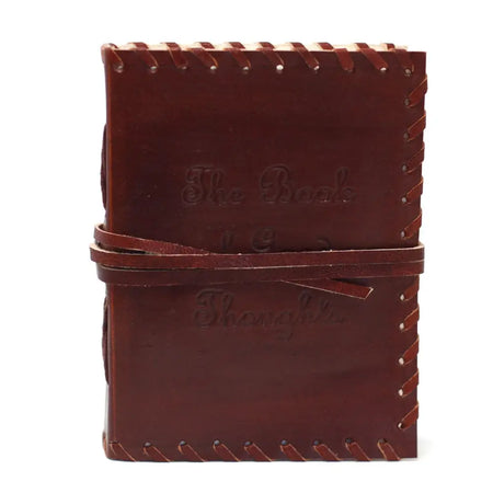 Brown leather notebook with stitched edges and wrap strap embossed with the book of thoughts text
