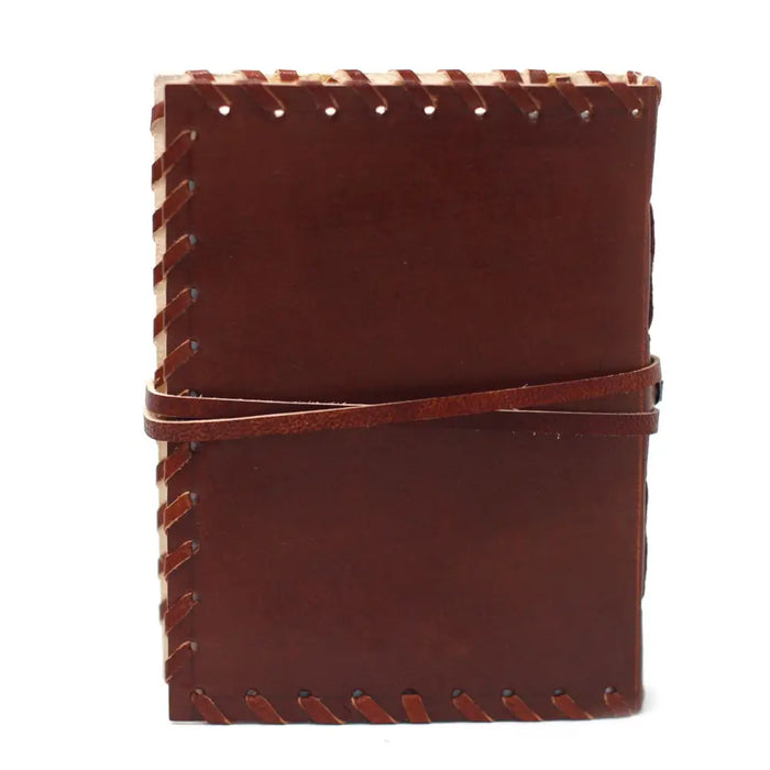Brown leather notebook with visible stitching and wrap strap sized 6 by 4 for jotting down thoughts