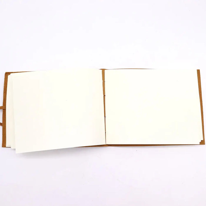 Brown leather sketchbook with cream blank pages featuring a golden tree design 9 by 7 inches