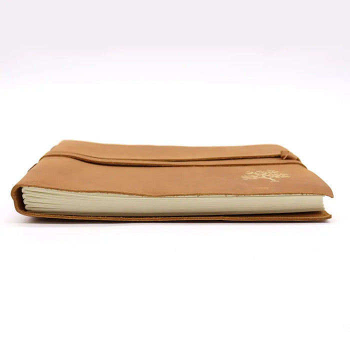 Tan leather sketchbook with a subtle gold tree emblem on the cover sized 9 by 7 inches