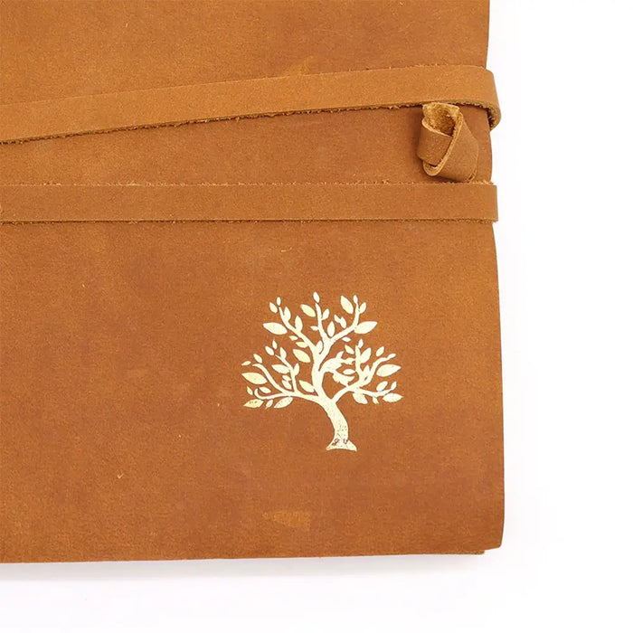 Brown leather sketchbook with a golden tree embossed on the cover and matching strap closure measuring 9 by 7 inches