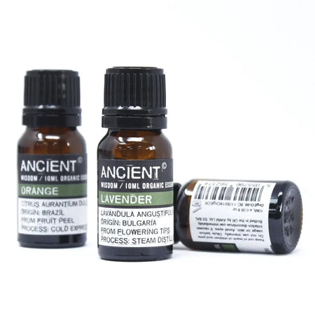 Two amber glass bottles with black caps and white labels show orange from brazil and lavender from bulgaria in lemon organic essential oil packaging with allergen declarations