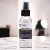 Silver aluminum spray bottle with black cap labeled ancient wisdom aromatherapy mist lemon verbena essential oil