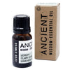 A small amber glass essential oil bottle with a black cap labeled less stress oil blend with lemon clary sage and lavender