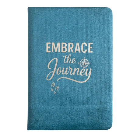 Light blue velvet notebook with teal textured cover and embrace the journey print featuring a compass design
