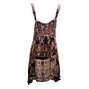 A flowing sleeveless light cotton indian dress with thin straps and a vibrant cotton indian print in earthy tones