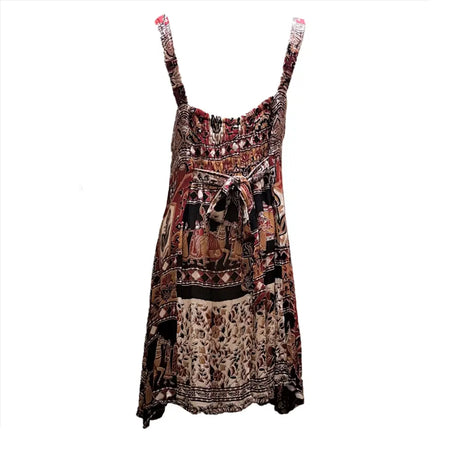 A flowing sleeveless light cotton indian dress with thin straps and a vibrant cotton indian print in earthy tones
