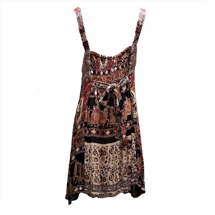 A flowing sleeveless light cotton indian dress with thin straps and a vibrant cotton indian print in earthy tones