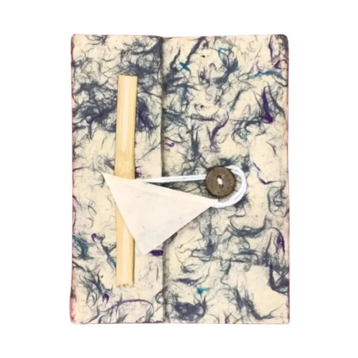 A lokta cotton notebook with cream cover and purple blue swirls secured by white cord and brass button 8x6 inches