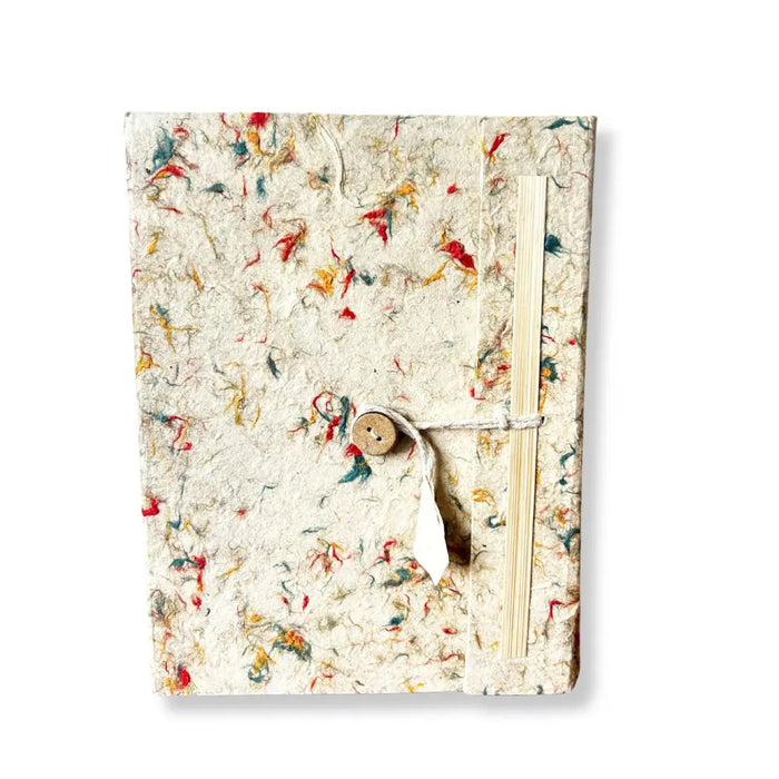A lokta cotton notebook with mixed colour fibres, off-white textured cover, wooden button, and twine closure