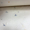 White lokta craft paper with subtle blue cornflower petal patterns for gift wrapping and lokta craft projects