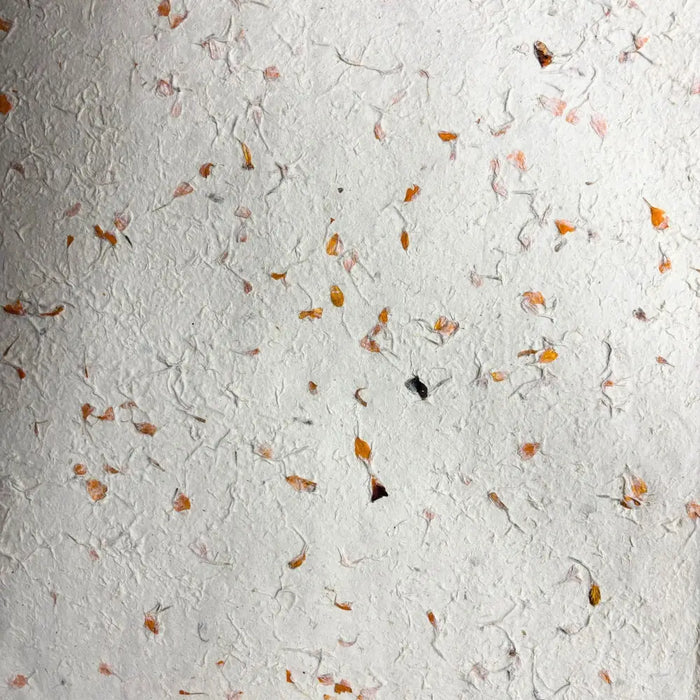 White textured lokta paper with embedded orange marigold petals for gift wrapping in a set of five sheets