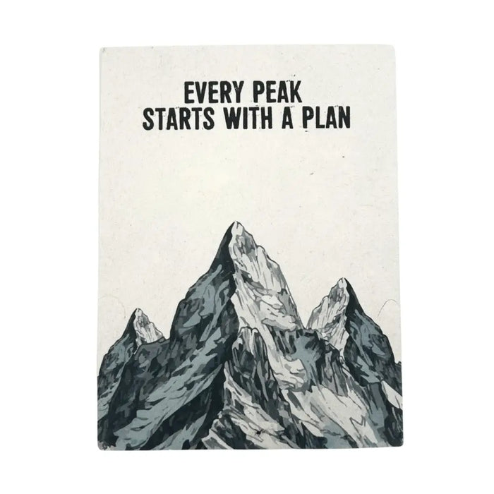 An off-white lokta paper notebook with a black and gray mountain range and every peak starts with a plan text