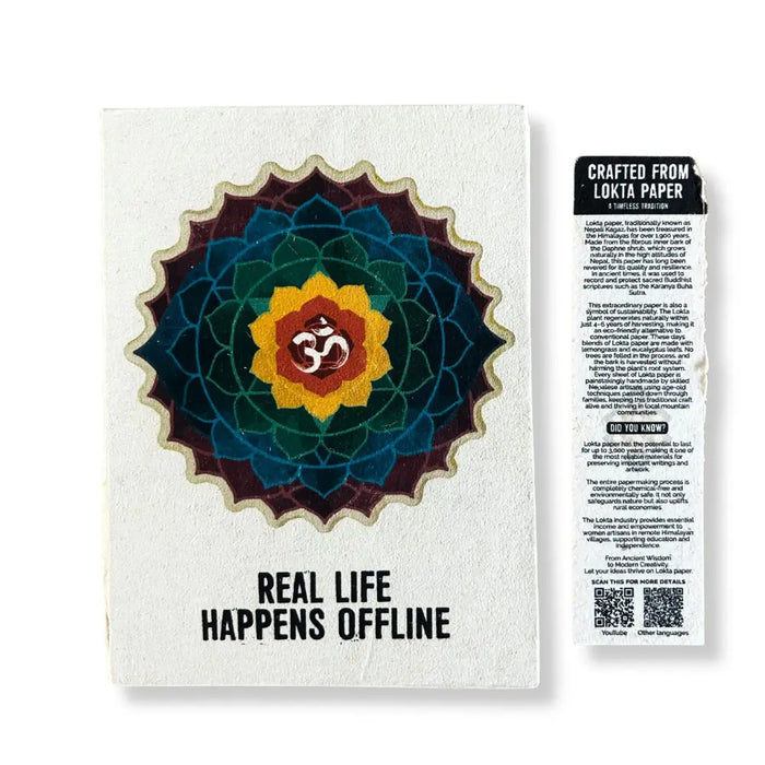 A white lokta paper notebook with a colorful mandala and om symbol, titled real life happens offline 8 by 6 inches