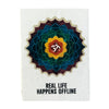 A textured white lokta paper notebook with a colorful mandala and om symbol titled real life happens offline