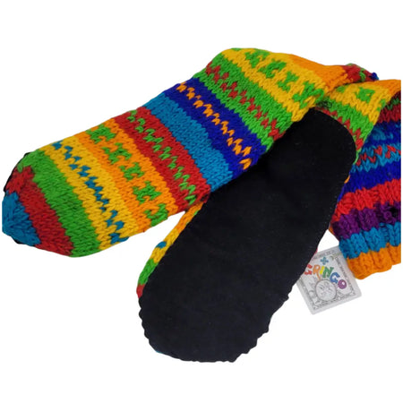 Long 100% wool slipper socks in rainbow stripes with black fleece lining and colorful gringo brand tag visible