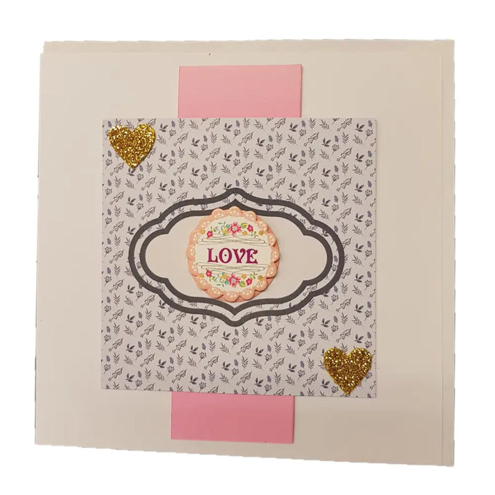 A delicate pink and gold heart themed greeting card with a floral love centerpiece from milford haven