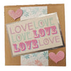 A pink glitter heart embellishment on a love themed greetings card from milford haven