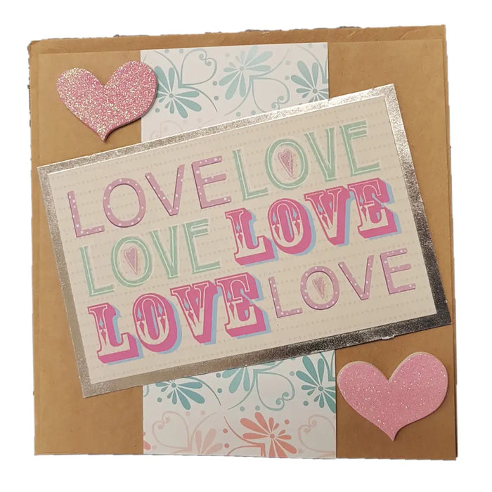 A pink glitter heart embellishment on a love themed greetings card from milford haven