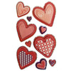 A collection of red and pink heart stickers with glittery edges and patterns like polka dots crosses stripes and floral designs
