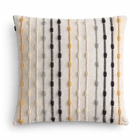 A square off-white cushion cover with vertical textured yarn stripes in black mustard yellow and gray hippie knot design