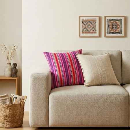 Vibrant multicolored woven cushion cover with neon stripes resting on a beige sofa for classic comfort
