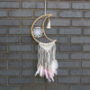 Macrame dreamcatcher moon shaped like a crescent with light brown bamboo blue and pink crochet and soft white pink feathers