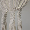 Cream-colored cotton rope chandelier with intricate braided design and tassels in natural cotton rope material
